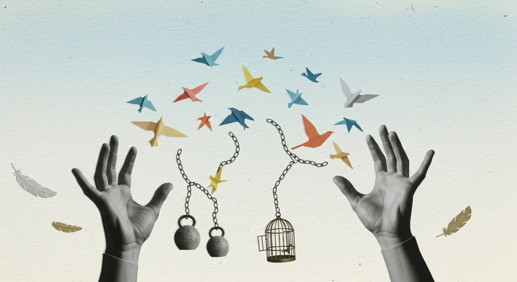 Hands releasing birds from their chained cages